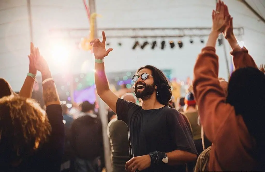 The Fun Festivals - People are Dancing in a Performance Tent at a Music Festival - Reasons to Visit England - Planet Travel Advisor The Fun Festivals - People are Dancing in a Performance Tent at a Music Festival - Reasons to Visit England - Planet Travel Advisor