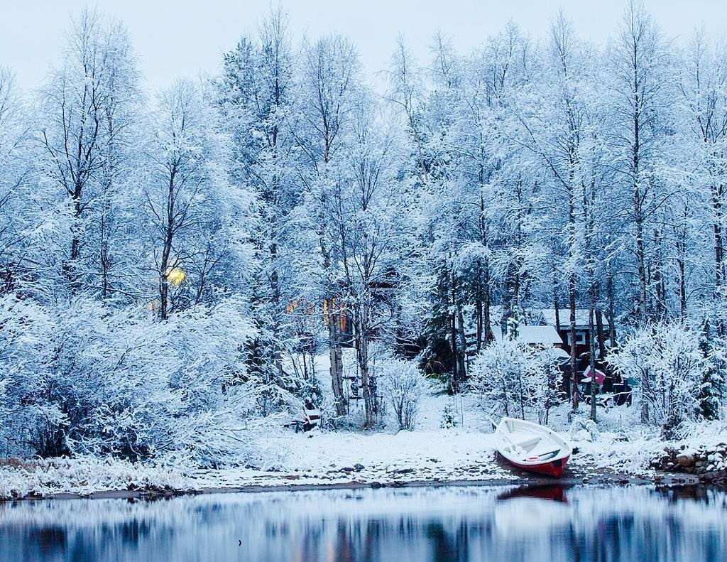 wight winter - Snow covering winter morning on Lake Inari with boat on foreground in Finland - Places to Visit in Finland - Planet Travel Advisor