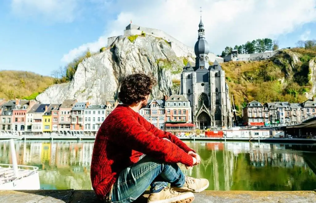 Man looking towards Dinant village in Belgium - Best Places to Visit in Europe - Planet Travel Advisor Man looking towards Dinant village in Belgium - Best Places to Visit in Europe - Planet Travel Advisor