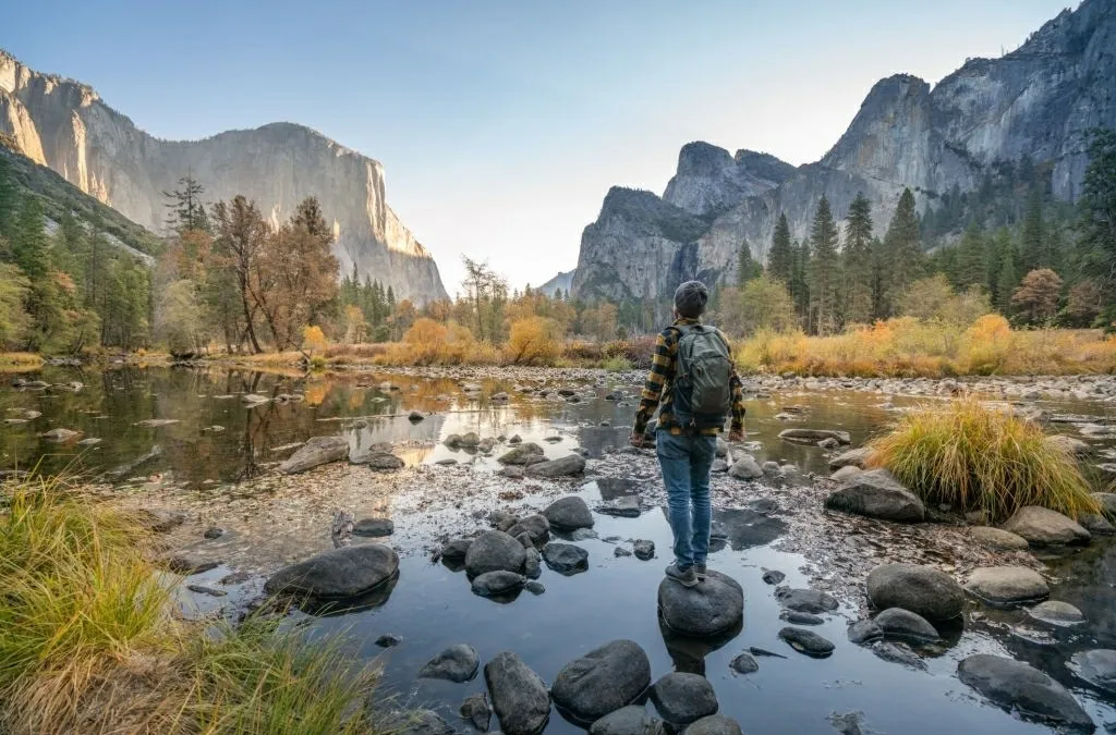 Young man contemplating Yosemite valley from the river, USA - Top-Rated Attractions & Things to do in USA