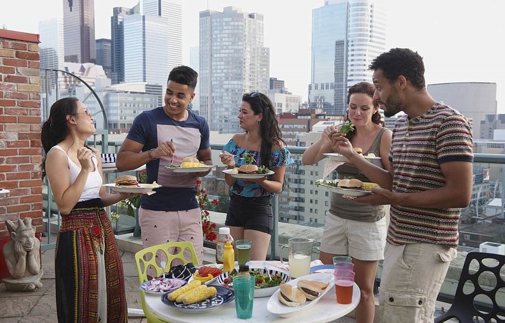 Friends enjoying barbecue on urban rooftop - Canada in Summer - Best Time to Visit Canada - Planet Travel Advisor