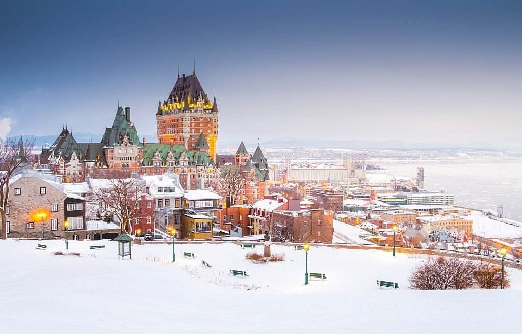 This is shot capture well known view of Quebec City, which including St.Lawrence river, houses, and Fairmont le Chateau Frontenac, the grand hotel - Planet Travel Advisor