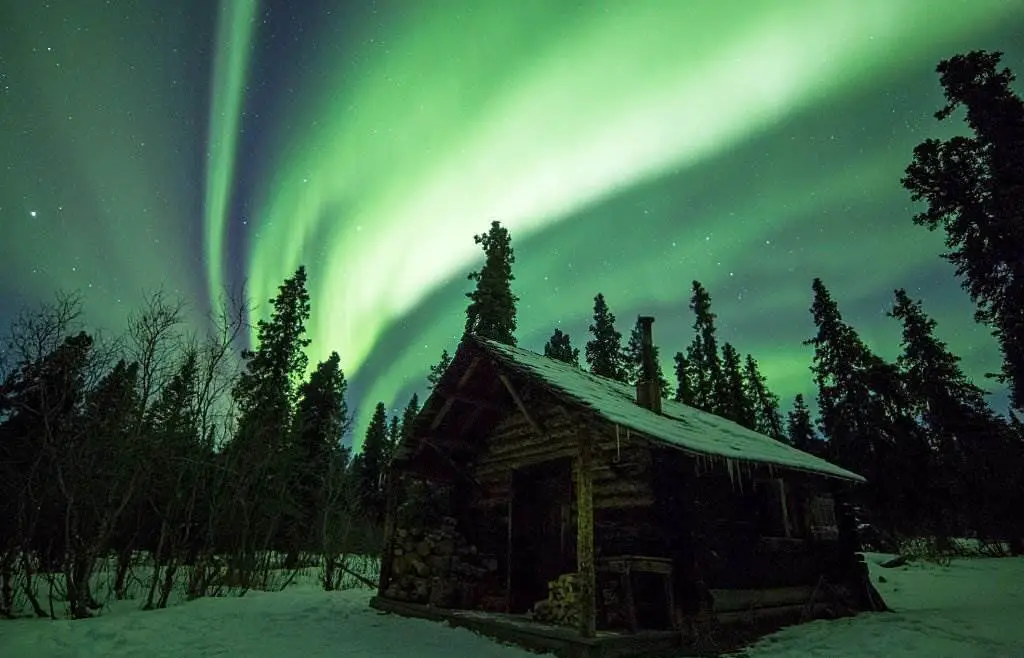 Denali National Park - Cabin under the Northern lights - Natural Attractions in USA - Planet Travel Advisor