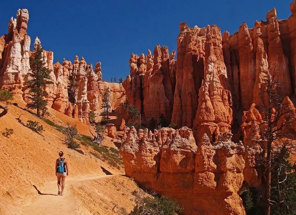 Girl walks amongst the hoodoos in Bryce Canyon National Park - Natural Attractions in USA - Planet Travel Advisor