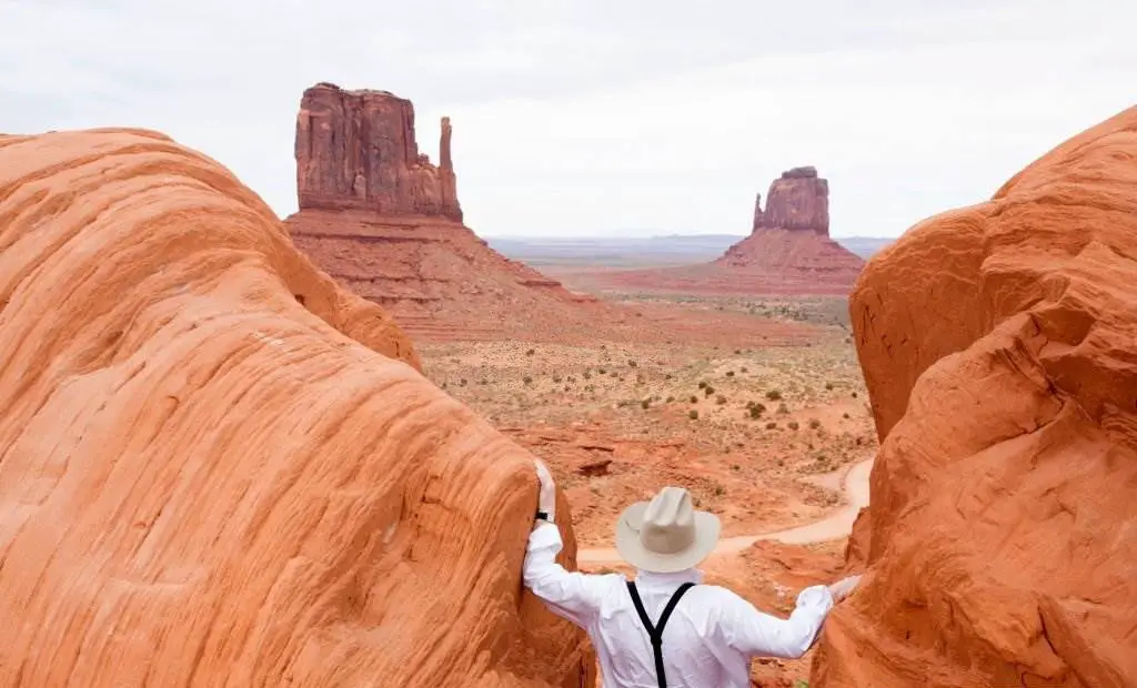 Monument Valley, man enjoying the view of Navajo Tribal park - Natural Attractions in USA - Planet Travel Advisor