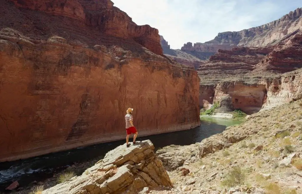 The Grand Canyon - A young woman takes in the view above the Colorado River at the Grand Canyon in Arizona - Natural Attractions in USA - Planet Travel Advisor