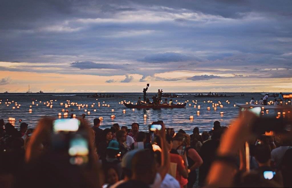 Crowds in Hawaii in March - People At Beach For Festival Against Sky During Sunset in Hawaii at Night - Planet Travel Advisor