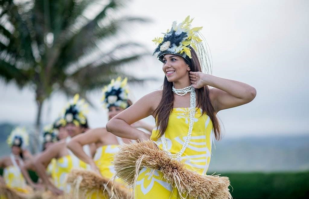 Events, Festivals Holidays in Hawaii in February - A group of women are doing a traditional Hawaiian dance during a luau for tourists on vacation - Planet Travel Advisor