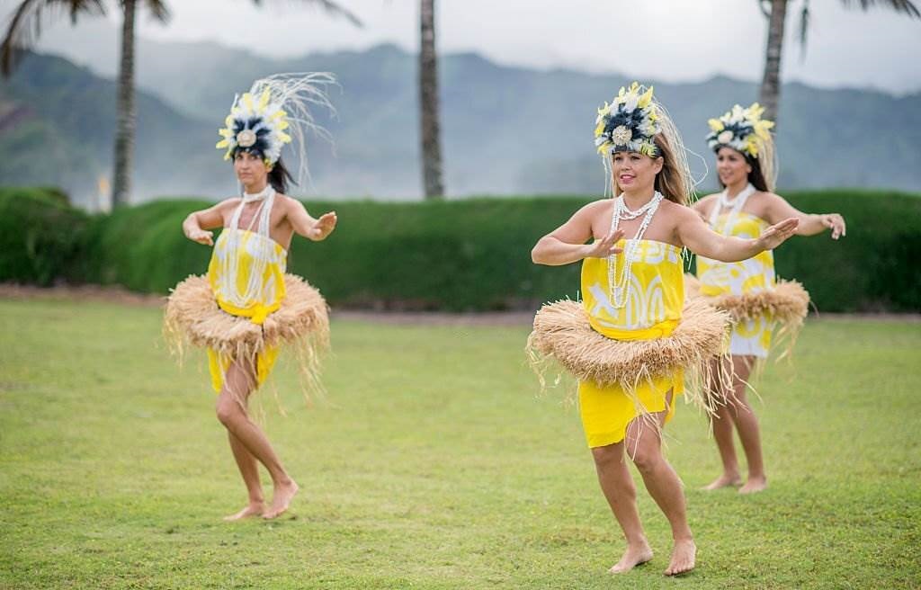 Events, Festivals Holidays in Hawaii in January - A group of women are doing a traditional Hawaiian dance during a luau for tourists on vacation - Planet Travel Advisor