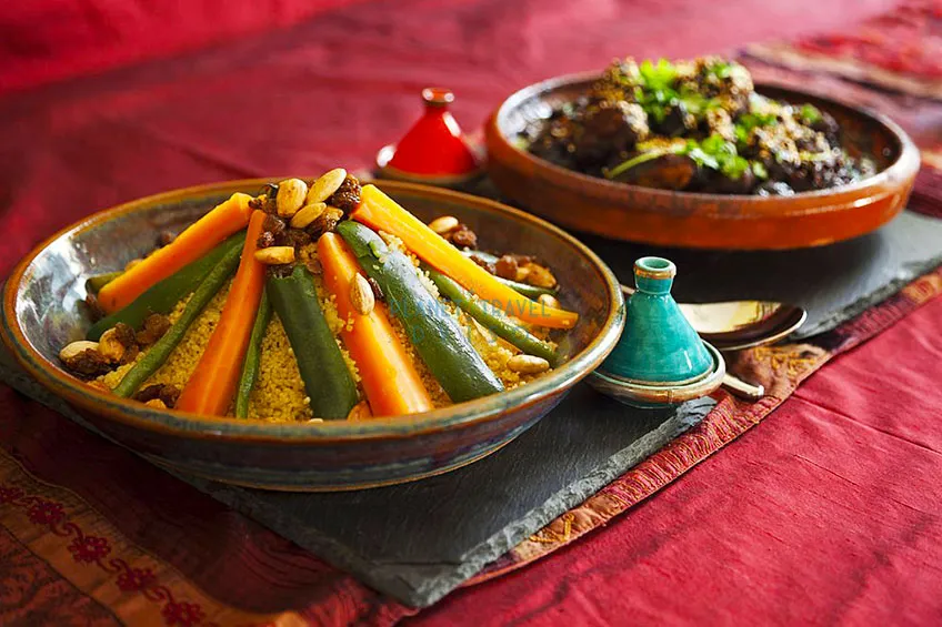 Vegetable couscous and Meat and prune tagine garnished with fresh coriander and sesame seeds - Best Time to Visit Morocco - Planet Travel Advisor
