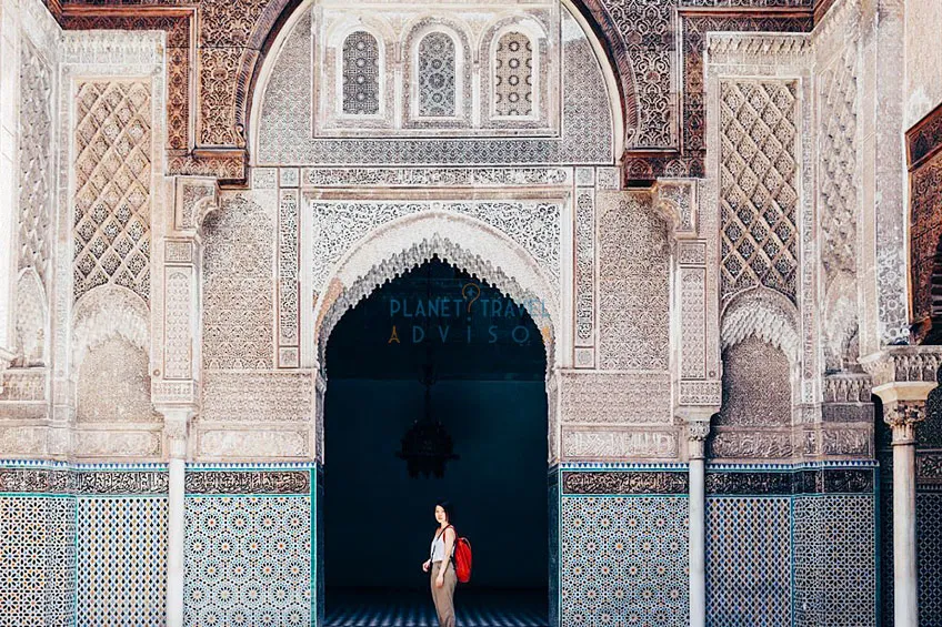 Women tourist visiting old temple in Marrakech - Best Time to Visit Morocco - Planet Travel Advisor