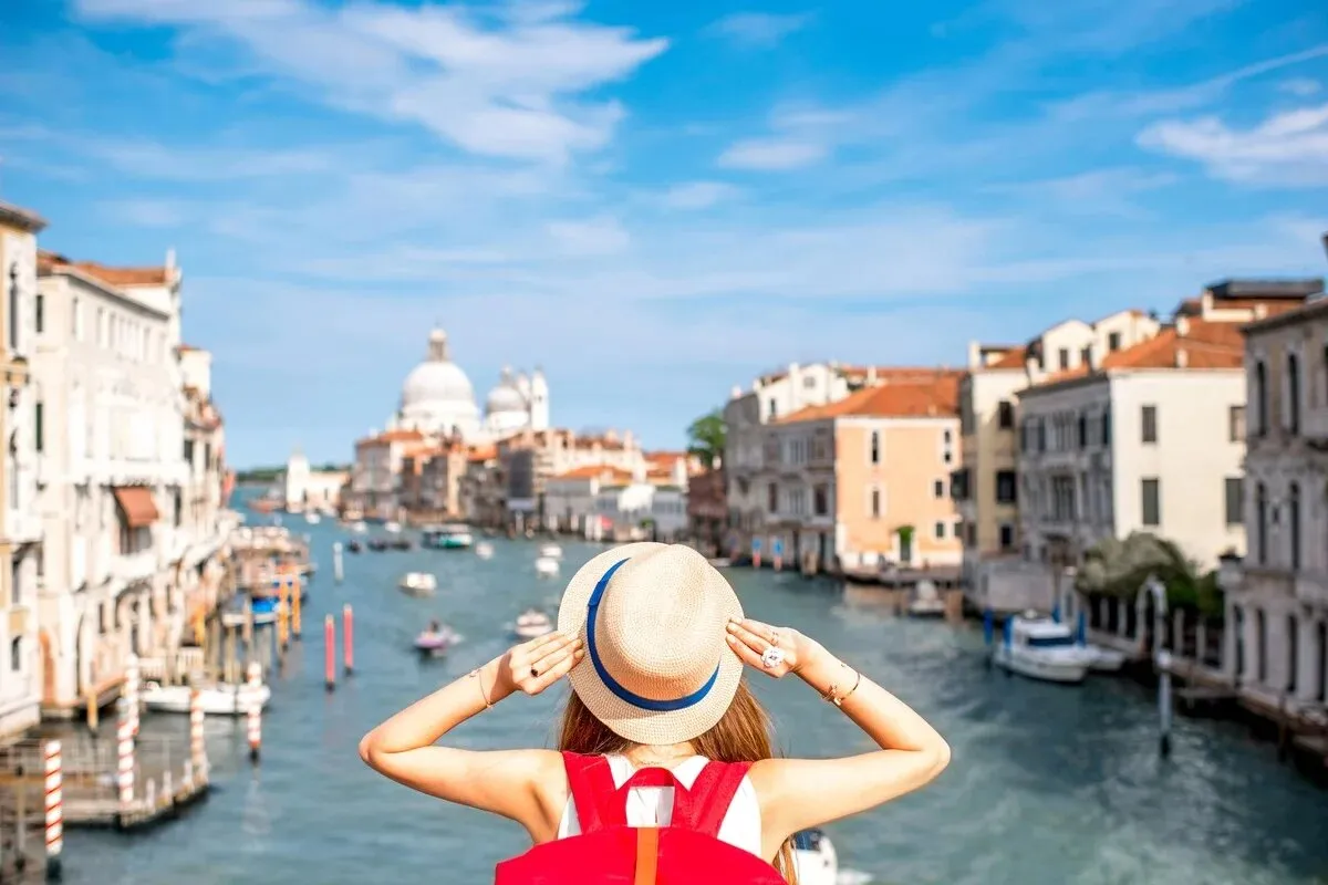 A Women Standing in A View in Italy - Where to Travel in January - Planet Travel Advisor