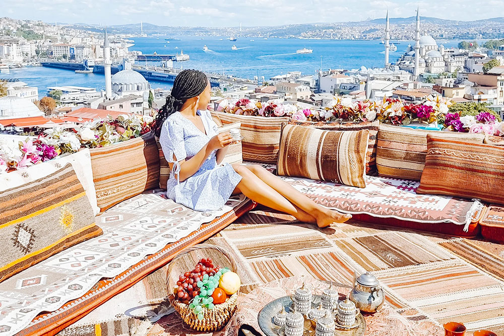 A Woman Sitting in a Cafe Overlooking Istanbul - Planet Travel Advisor A Woman Sitting in a Cafe Overlooking Istanbul - Planet Travel Advisor