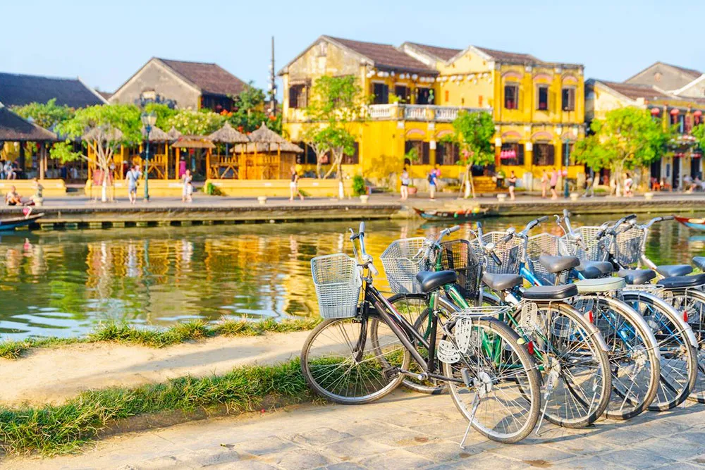 Bicycles Parked Beside the Thu Bon River in Hoi An Ancient Town - Planet Travel Advisor