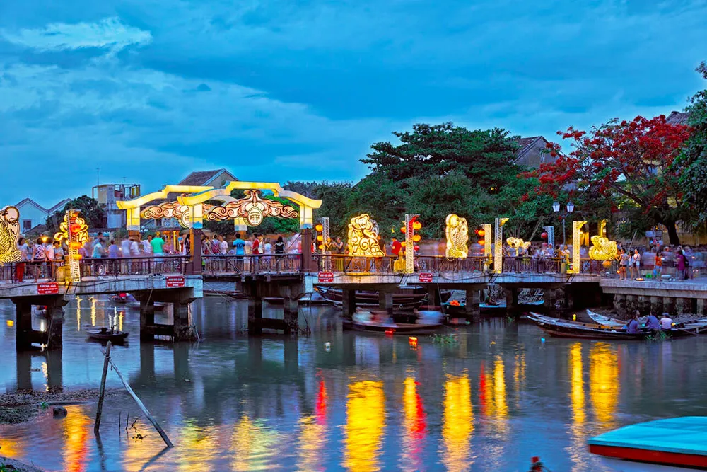 Cau an Hoi Bridge Illuminated at Dusk - Planet Travel Advisor