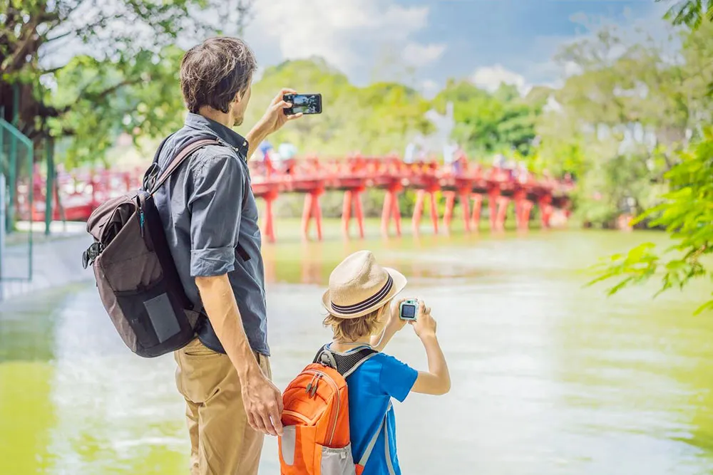 Father and Son by the Red Bridge in Hoan Kiem Lake - Planet Travel Advisor